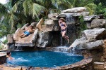 Front Yard Water Feature with Backyard Pool Remodel with Natural Stone Waterfalls in Osprey, FL